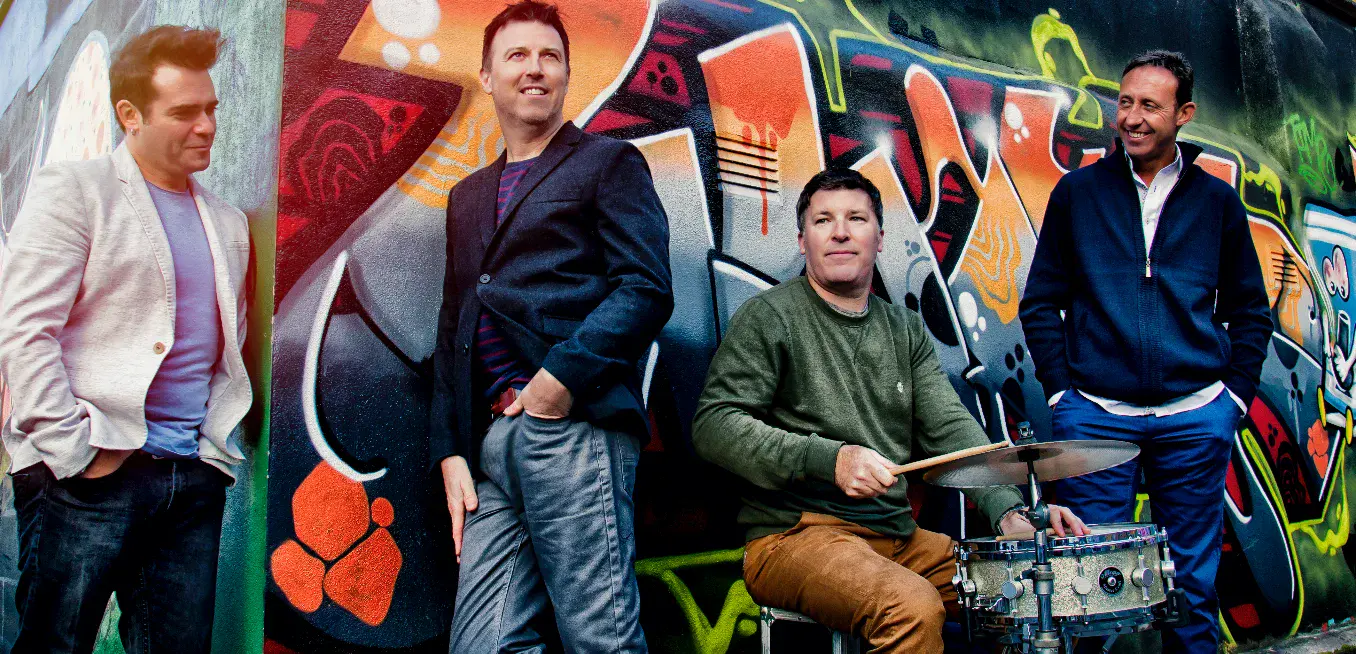 Sway Social band beside a graffiti wall